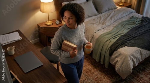Calm bedroom evening routine woman with book and warm drink before bed
