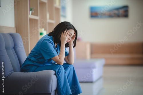 Tired nurse stressed healthcare worker female doctor hospital corridor burnout mental health exhaustion overworked sitting uniform Tired nurse stressed healthcare worker female doctor hospital