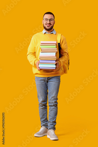 Male student with stack of ...
