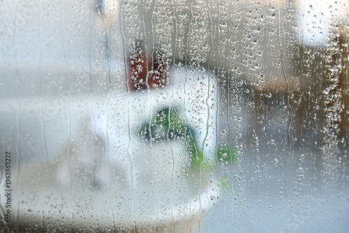 Water droplets on glass aga...