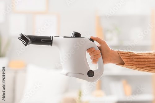 Female hand with steam clea...