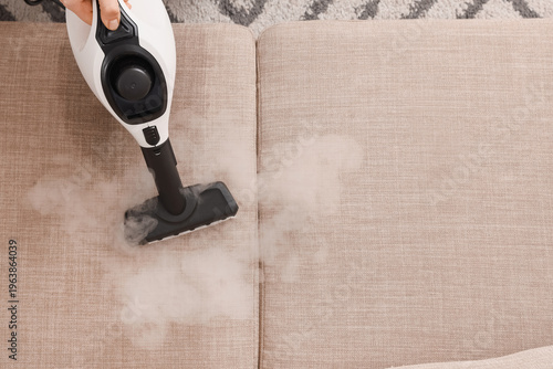 Female hand steam cleaning ...