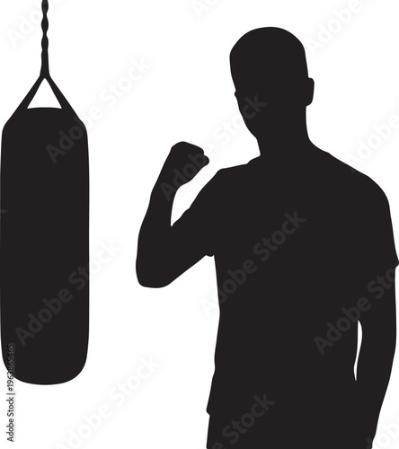 Silhouette of a Male Boxer with Clenched Fist Next to a Punching Bag