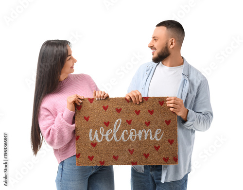 Young couple with doormat o...