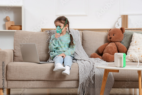 Cute little girl with lapto...