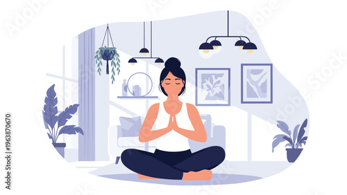 Calm young woman practices mindfulness meditation while sitting in a lotus position on the floor of her stylish modern living room.