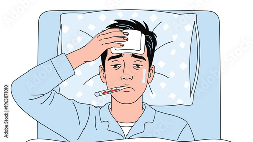 Sick young man lies in bed with a fever using a thermometer and a cooling compress on his forehead for relief from symptoms.
