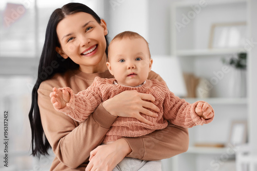 Young mother holding her li...