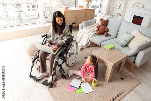Young Asian mother in wheel...