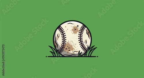 A worn baseball rests on green grass, ready for a game