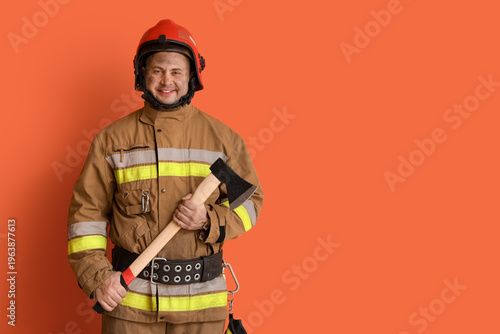 Male firefighter with axe o...