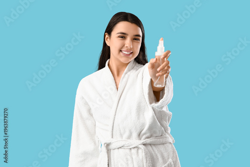 Young woman in bathrobe wit...