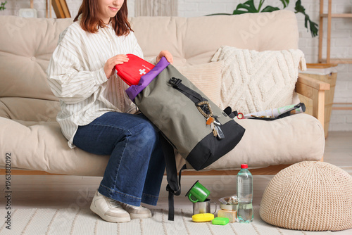 Young woman packing emergen...