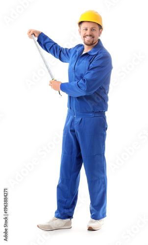 Male builder with tape meas...