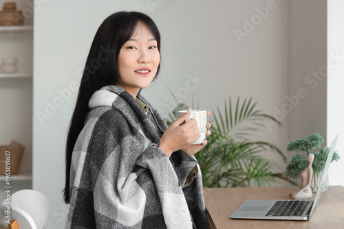 Young Asian woman with warm...