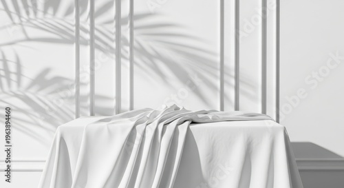 Minimalist white product display podium with draped fabric and palm leaf shadow on classic wall background