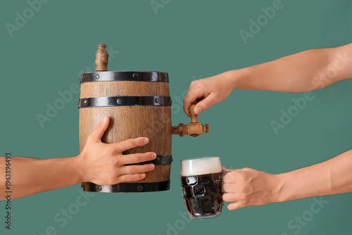 Male hands pouring beer fro...