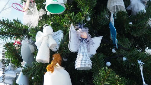 Charming winter decorations fill the air with joy as colorful ornaments dangle from the evergreen branches. Each detail sparkles, creating a magical scene of holiday spirit and cheer