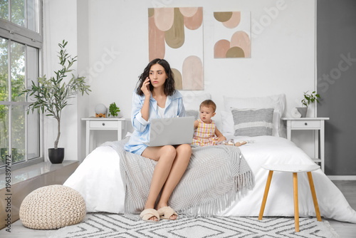 Working mother and her litt...