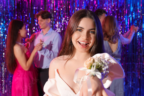 Young woman with corsage on...