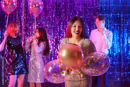 Young Asian woman with balloons on prom night