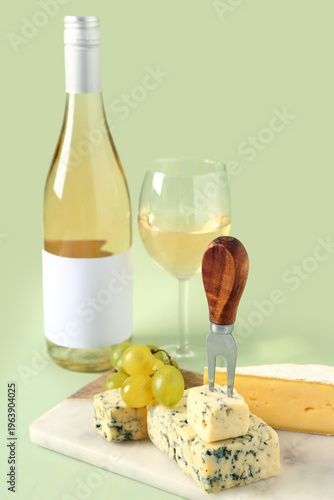Board with tasty cheese, gr...
