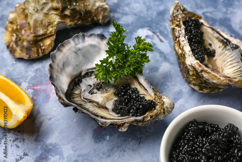 Εκτύπωση καμβά Tasty oysters with black caviar on blue background