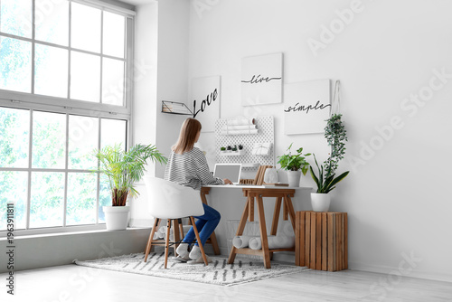 Young woman working at desk...