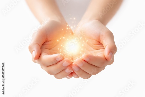 Cupped human hands holding glowing magical light and sparks, concept for hope, healing, and energy isolated on white background.