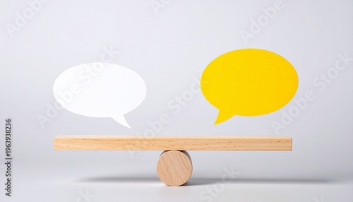 Wooden seesaw with speech bubbles symbolizing balanced communication