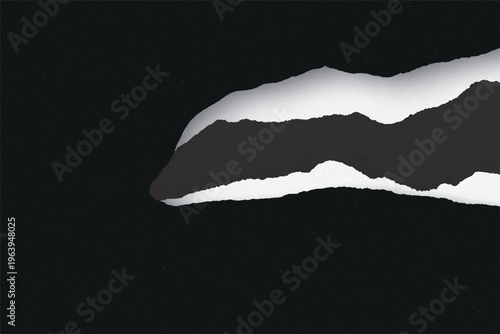 Torn black paper sheet revealing a white layer beneath with rough edges