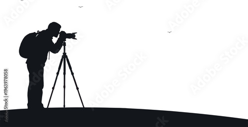 Photographer silhouette with backpack and camera on tripod capturing scenery outdoors.
