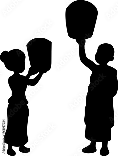 Silhouette of a Buddhist Monk and Nun Releasing Sky Lanterns for Vesak Day Celebration.Symbolic representation of Buddhist spiritual festivals, enlightenment,