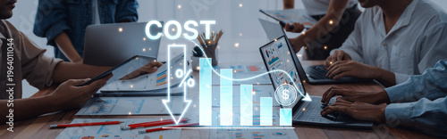 Cuadro en lienzo A dynamic business team collaborates on financial analysis and cost reduction strategies, utilizing laptops and tablets in a modern office environment