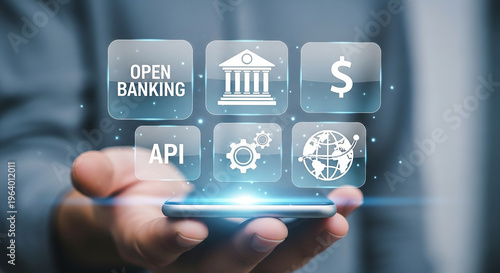 Open Banking Technology: A person's hand tenderly cradles a smartphone displaying an array of futuristic icons.