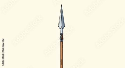 Traditional spear head made of metal with an ornate decorative base and a wooden shaft isolated on a light cream background.