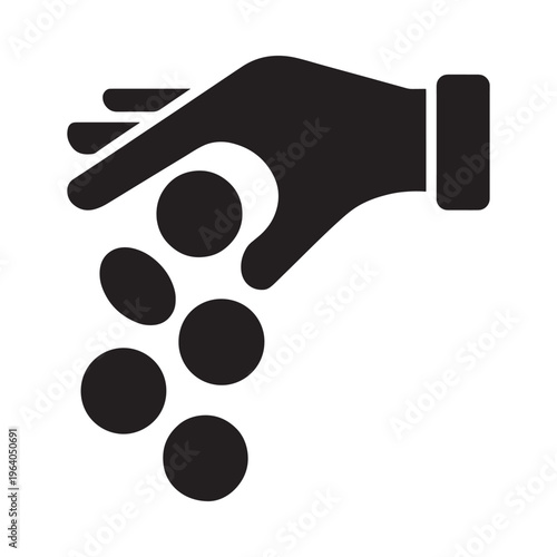 A black silhouette of a hand releasing or dropping several circular objects