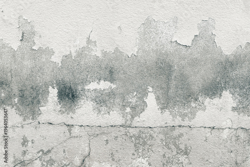 Weathered concrete wall with peeling paint, cracks, and rough texture, abstract grunge background in gray tones, ideal for industrial or vintage design use.
