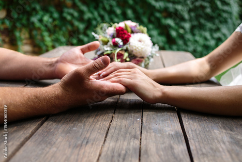A man and a woman holding hands. Hands close-up