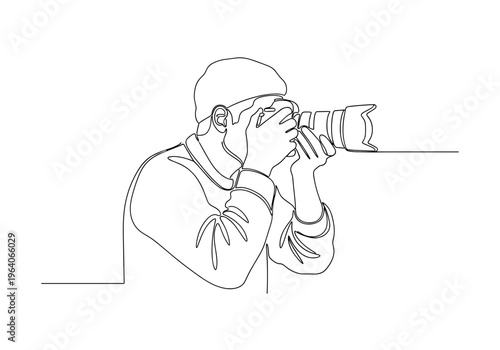 Male photographer taking photo with camera on minimalist background