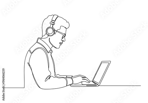 Male programmer working on laptop with headset on minimalist background