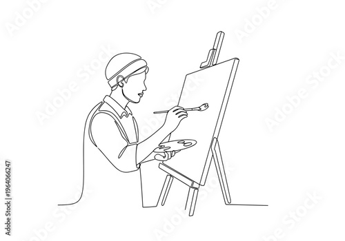 Male painter painting on canvas at easel on minimalist background