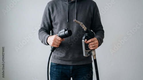 Person holding electric vehicle charging connectors. Energy Crisis concept