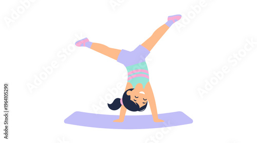 Young girl performing a handstand on a yoga mat.
