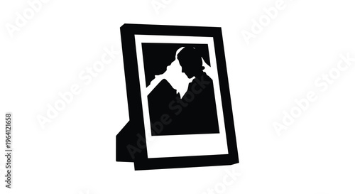 A framed photograph displaying a dark silhouette of a person s head and shoulders silhouette