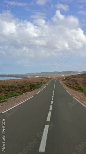 View from a car driving on the road along the Atlantic coast, Morocco, Africa. Vertical video