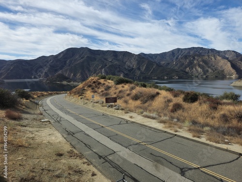 Winding Mountain Road Beside Lake in Dry Scenic Landscape