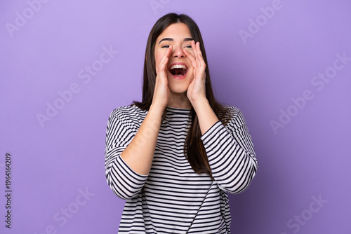 Obraz na plátně Young Brazilian woman isolated on purple background shouting and announcing some