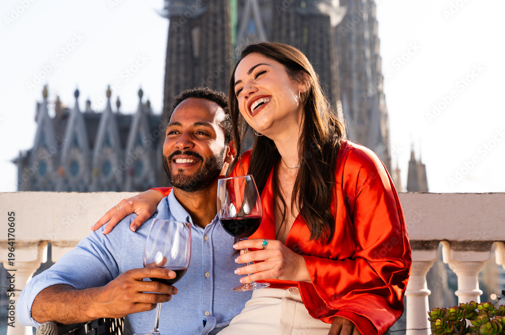 Obraz premium Multiracial beautiful happy couple of lovers dating in Barcelona on a rooftop with amazing city view