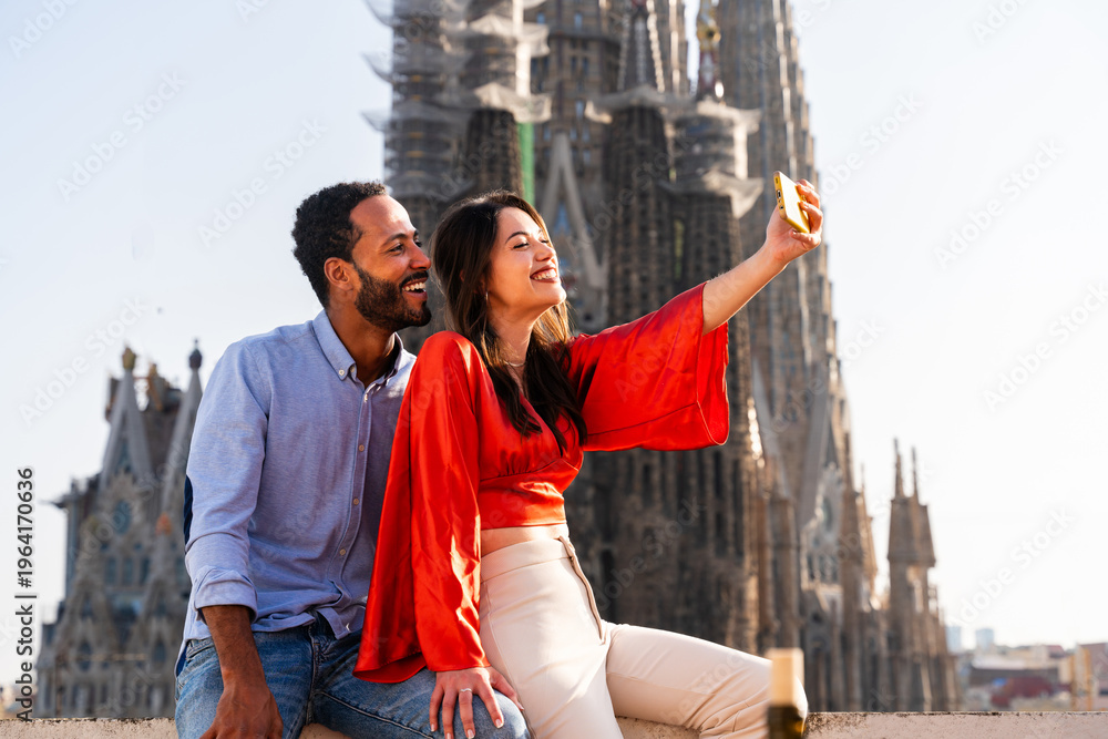 Obraz premium Multiracial beautiful happy couple of lovers dating in Barcelona on a rooftop with amazing city view